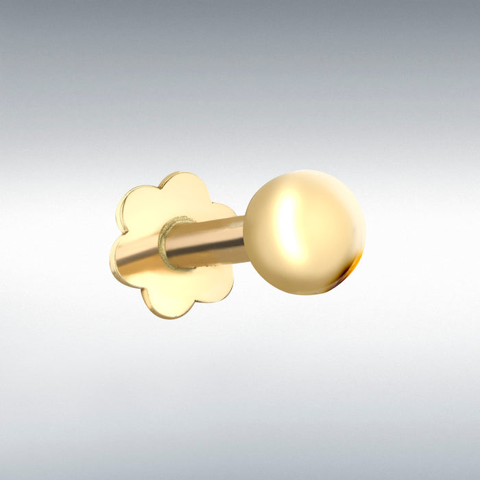 Gold labret stud earring on a light gray background