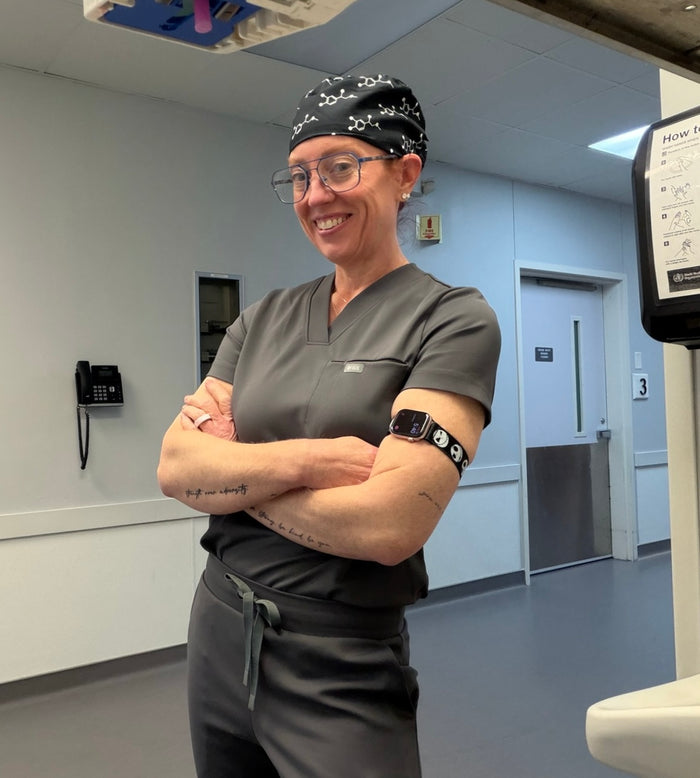 Ladyspinedoc in medical scrubs standing in a hospital room with medical equipment.