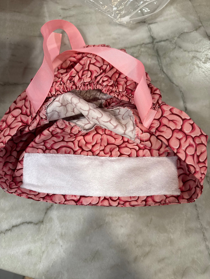 Flat lay of the opening of the Cortex Cap - Pink Scrub Hat with Brain Design showing the small sweatband inside
