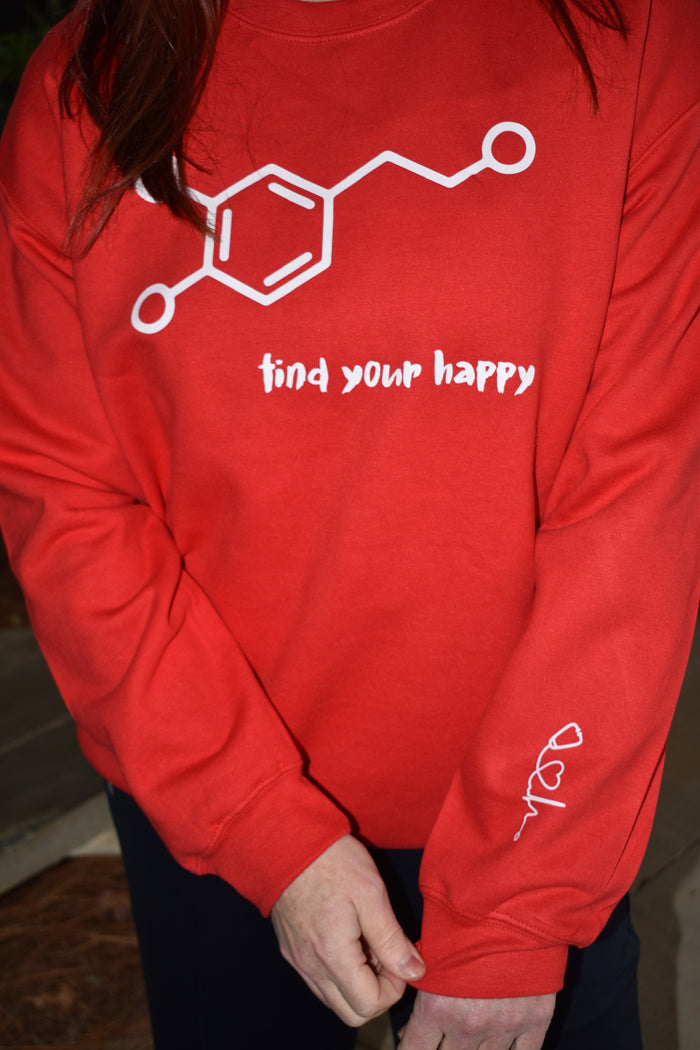 Dr. Betsy Grunch wearing the red Dopamine Molecule Sweatshirt, a cozy and stylish piece celebrating happiness and brain science.